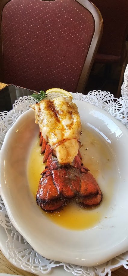 Plates of seafood dishes on a restaurant table.